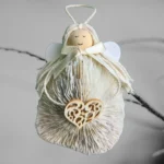 Adorable Handmade Shell Angel made of light seashell, wooden heart and bow.