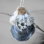 Beautiful and Unique Handmade Christmas Shell Decoration made of blueish seashell and wooden flower.